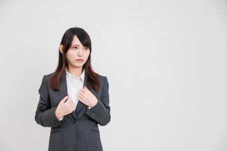 A businesswoman in an intimidating suit with her arms crossedの写真素材