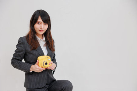 Woman in a suit with a yellow chekiの写真素材