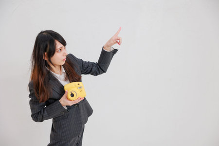 Woman in a suit with a yellow chekiの写真素材