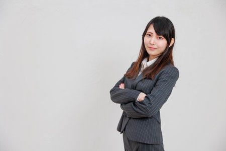 A businesswoman in an intimidating suit with her arms crossedの写真素材