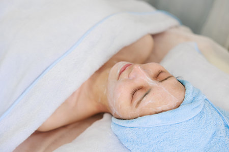 Beautiful woman getting facial massage in spa salon. Beauty treatment conceptの写真素材