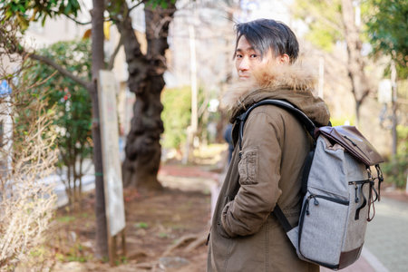 Asian woman with backpack walking in the city. Travel and tourism concept.