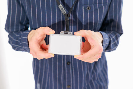 Man holding a digital camera. Isolated on a white background.の写真素材
