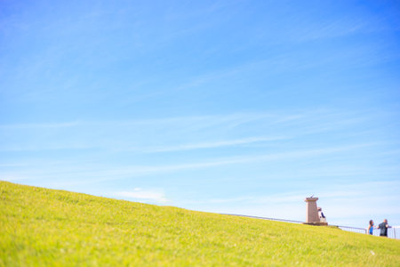 People walking on the top of the hill with blue sky background.の写真素材