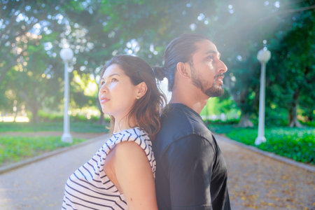 Couple in love walking together in the park. Young Asian man and woman embracing in the park.