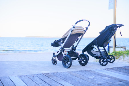 Baby stroller on the beach by the sea, shallow depth of fieldの写真素材