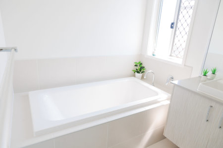 Bathroom interior with white bathtub and sink. Nobody inside