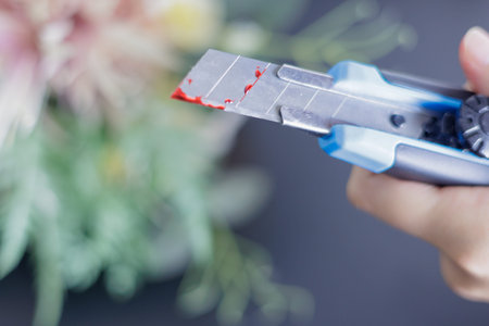 Close up of florist cutting flower with scissors. Selective focus.
