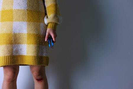 Little girl in a yellow plaid coat