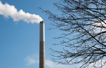 White smoke comes out of a smoking chimney