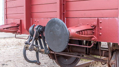 Old train carriage on rails, Red wooden train carriage. Old style hook railway coupling and buffers...