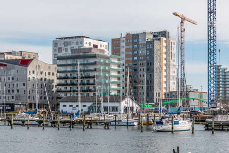 Aarhus, Denmark - 24 march 2020:  Aarhus yacht harbor with yacht in the water, Aarhus o in the background. grundfos college in the background. many new buildings in aarhus harbor areaのeditorial素材