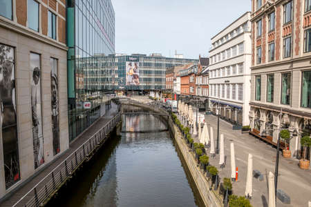 aarhus, Denmark - 24 march 2020:  Promenade along the river Aarhus A in the city center of the town of Aarhus. Stores and offices on both sides, Magasin Shopping center in the backgroundのeditorial素材