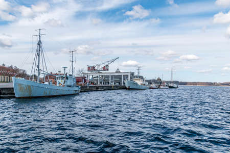 Mariager, Denmark - 29 march 2020: Scene from a Danish port with a grey wishing boat, Mariager, Denmarkのeditorial素材