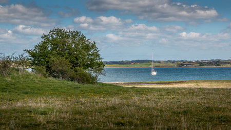 A yacht licks for anchor in Kalovig. beautiful nature with the church in the background. National...
