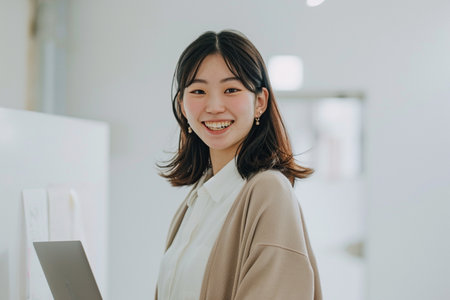 Portrait of young asian businesswoman using laptop computer in officeの素材