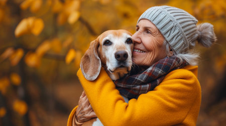 Happy senior woman with her dog in autumn park. Mature woman with her pet.の素材