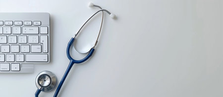 Stethoscope and computer keyboard on white background with copy space.の素材