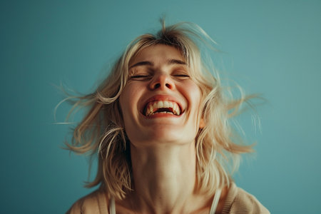 Portrait of beautiful young woman with flying hair and closed eyes.の素材