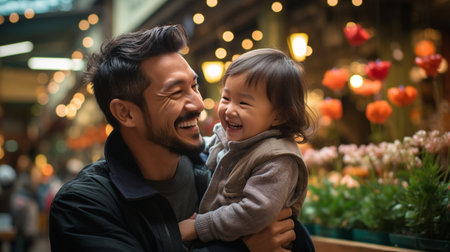 Happy asian father and his adorable little daughter having fun together in the city.の素材