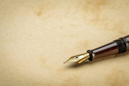 Fountain pen on old paper background with copy space for text.の素材