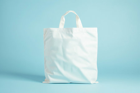 White cotton bag on blue background. Minimal concept of shopping.の素材