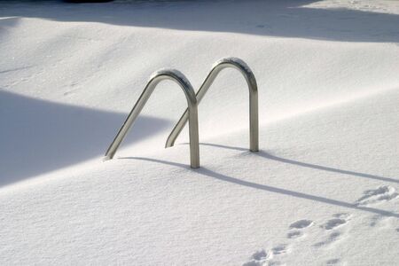 Pool steps covered in snow; hot and coldの写真素材
