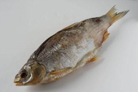 Dried salted fish on a white background, close-up