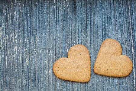 Grey wooden aged background with ginger bread biscuits. Saint valentines frame with copy space. Love and wedding invitation wallpaper. Sweetheart composition. Be my Valentine. Togethernessの写真素材
