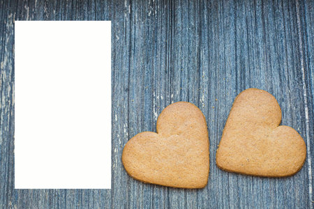 Grey wooden background with white copy space and ginger bread biscuits on right. Saint valentines frame. Love and wedding invitation wallpaper. Sweetheart composition. Be my Valentine. Togethernessの写真素材
