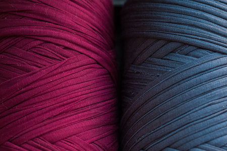 Two skeins of knitted yarn. Grey and burgundy knitting threads for bags and home design. Two colour textured background for web design. Textile production material. Fashion industry wallpaper. Handicrafts . High quality photoの写真素材