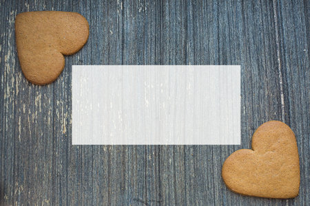Grey wooden aged background with ginger bread biscuits in two corners wight copy space . Saint valentines frame. Love and wedding invitation wallpaper. Sweetheart picture. Be my Valentine.の写真素材