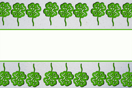 Upper and lower border with line of quatrefoils. Copy space in middle with green lines. Grey background. Good luck symbol. Natural health and freshness concept. Floral design. Illustration. plantの写真素材