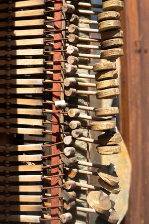 piano tuning pegs and hammers in bright sunshine. Inside parts of wooden musical instrument. Vintage harpsichord detail. Background and wallpaper picture. Art and sound concept. Ageingの写真素材