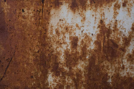 old rusty iron sheet covered with brown rust and grey paint. Background and wallpaper picture. Corrosion. Ecological pollution concept. Reconstruction and reparation needed. Ugly metal surfaceの写真素材