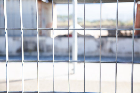 Closeup of a metal fence with a blurred background