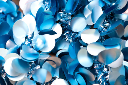 Close up view of shimmering blue and white sequins on fabricの写真素材