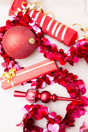 A lovely assortment of bright red Christmas decorations displayed on a tableの写真素材