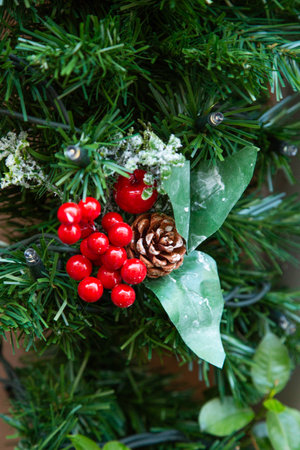 A closeup of a beautiful Christmas wreath with red berries and pine conesの写真素材
