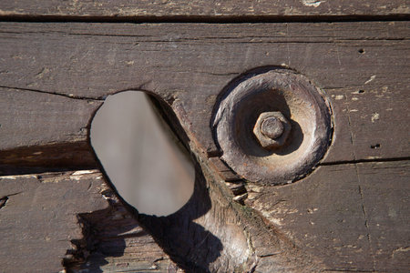 This image shows a closeup of a wooden piece with a screwの写真素材