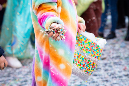 A child in a unicorn costume holds a bag of confettiの写真素材