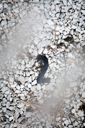 The number 2 is clearly painted in a bright color on a pile of white gravelの写真素材