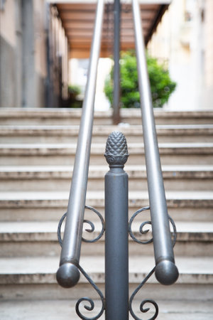 This is a close up view of a metal railing that is present on a set of stairsの写真素材