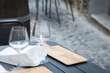 A table set with two elegant wine glasses and a napkinの写真素材