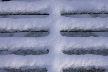 Fresh fallen snow on a bench to show texture