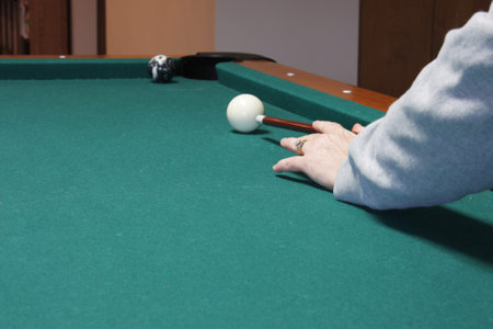 Shooting the eight ball in the corner pocket to win the game of pool