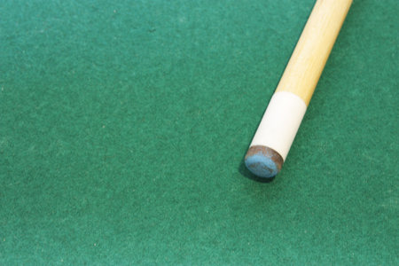 Pool stick with chalk on the tip used to play pool