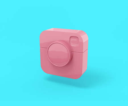 Pink camera popular social network on a blue background. Minimalistic design object. 3d rendering icon ui ux interface element.の写真素材