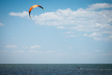 Paraglider in the sea on a background of blue sky