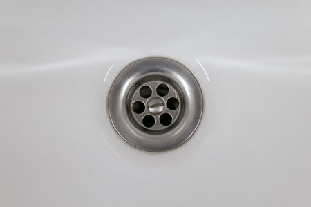 Drain in a white ceramic sink. Backgroundの写真素材